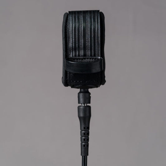 Back view of Deflow 9ft 7mm black knee leash with secure strap design.