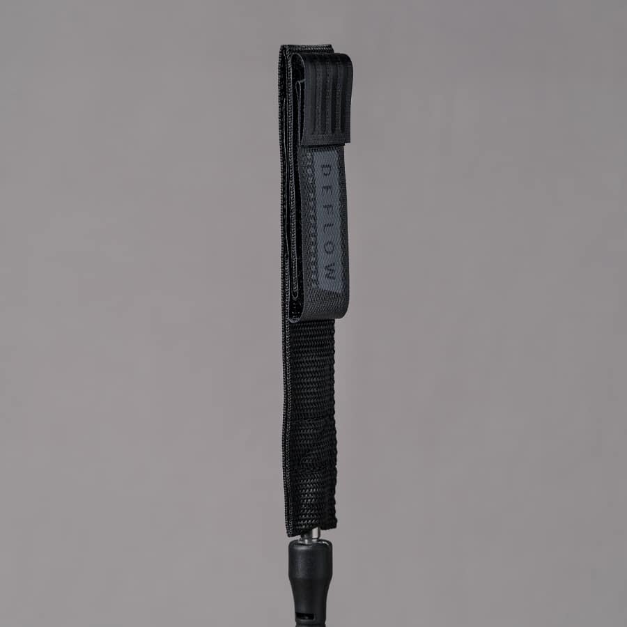 Side view of Deflow 9ft 7mm black knee leash showcasing sturdy strap.