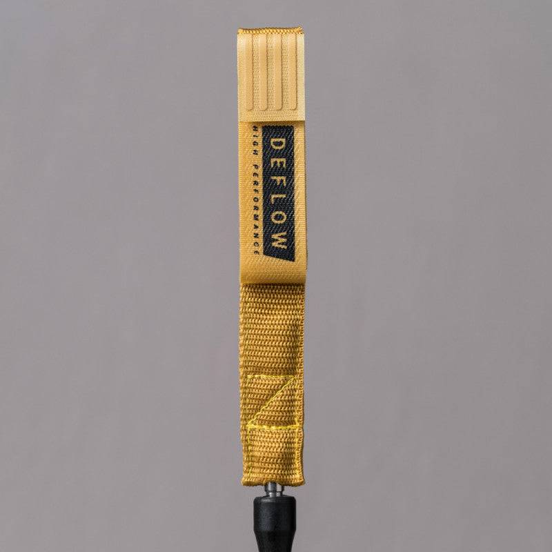 Detailed view of Deflow 9ft 7mm leash strap with mustard finish and logo.